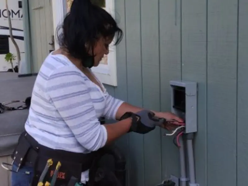 Licensed electrician wiring an exterior subpanel in Londonderry